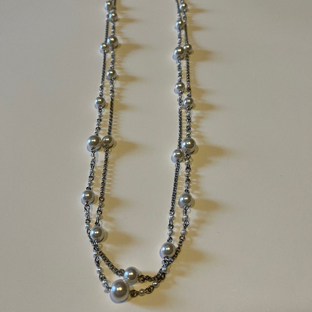 Double strand 24 inch silver colored and pearl like necklace